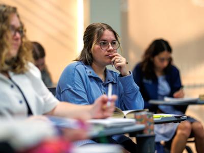 Female student thinking at desk